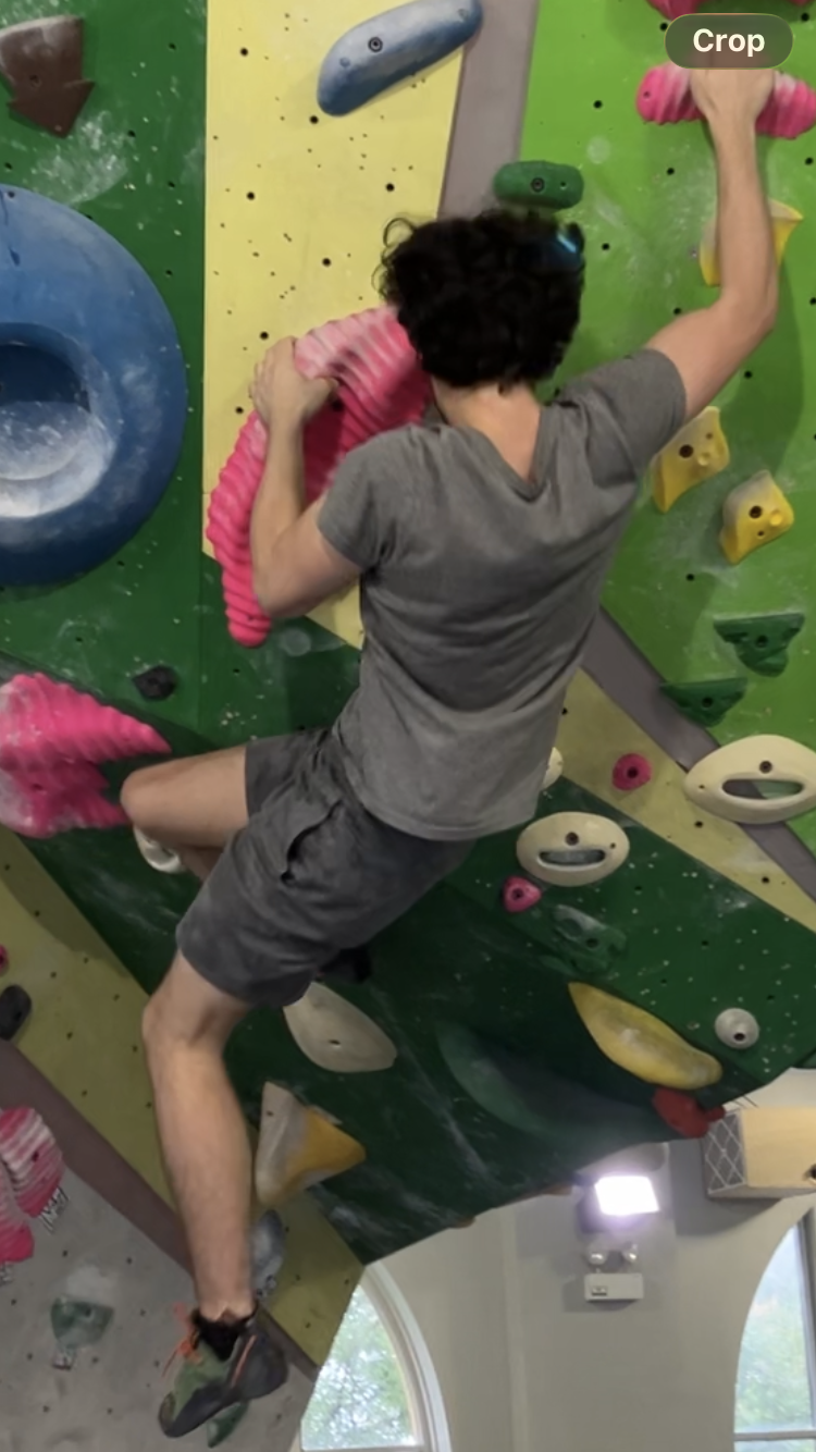 Rudra climbing a V4 boulder